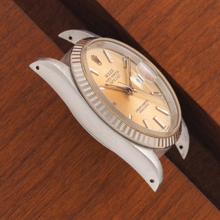 Angled top view highlighting the sharp lug proportions and vibrant tropical peach dial on a Rolex Datejust 16234