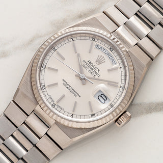 Angled view showing the fluted bezel and angular white gold case of a Rolex Day-Date Oysterquartz 19019