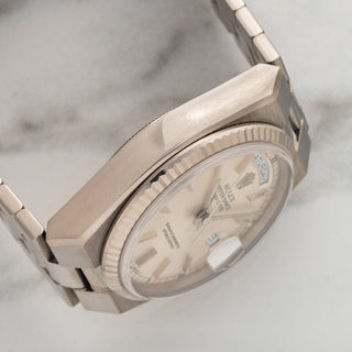 Angled profile view displaying the sharp, geometric case edges and signed crown of a white gold Rolex 19019
