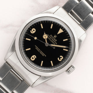 Angled shot highlighting the glossy black gilt dial and golden-khaki tritium patina on a 1967 Rolex Explorer 1016