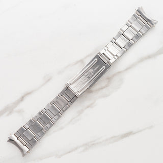 Underside view showing the stretch rivet link construction and folding clasp blades of a vintage Rolex Oyster bracelet