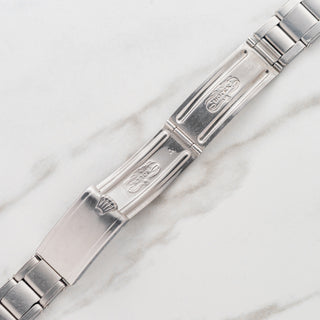 Close-up view of the period-correct date stamp and coronet on the folding clasp of a vintage Rolex Oyster bracelet