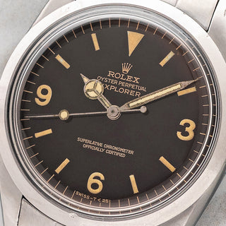 Macro close-up shot of the tropical chocolate gilt dial, 3-6-9 numerals, and warm tritium patina on a 1965 Rolex Explorer 1016