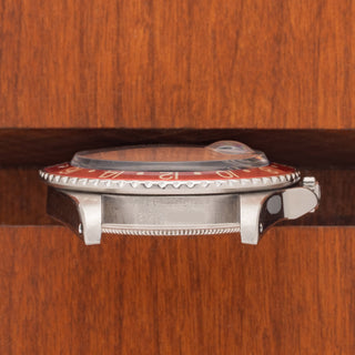 Horizontal case profile showing the thick crown guards, signed crown, and Pepsi bezel edge on a Rolex 16750