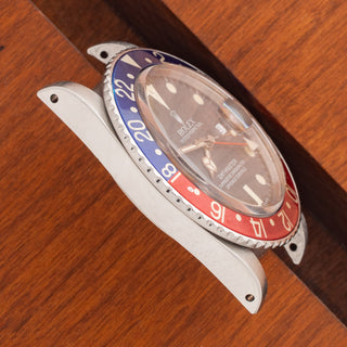 Angled top perspective showcasing the sharp case bevels and red and blue bezel insert on a 1985 Rolex 16750