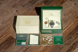 Complete full set presentation of the Rolex GMT-Master II 116710LN including original box, warranty card, booklets, and hangtags