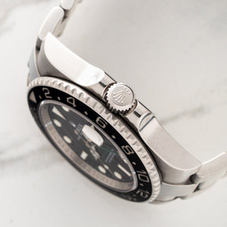 Side profile view showcasing the Triplock winding crown, crown guards, and ceramic bezel edge on a Rolex 116710LN