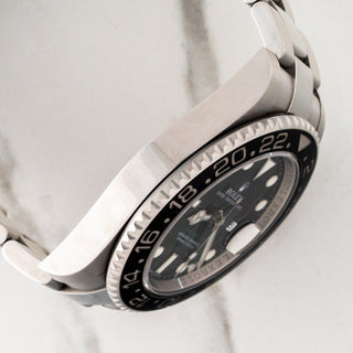 Side view displaying the thick stainless steel case profile and polished side finishes on a Rolex GMT-Master II