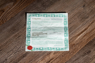 Original open punched paper warranty certificate accompanying an 18k gold Rolex Oyster Perpetual 14238