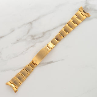 Top view of the authentic 18k yellow gold 7205 rivet Oyster bracelet detached from the case