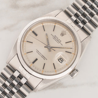 Angled view highlighting the smooth stainless steel bezel and silver dial on a 1971 Rolex Datejust 1600