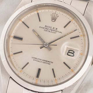 Macro close-up shot of the silver sunburst pie-pan dial and tritium lume plots on a Rolex Datejust 1600