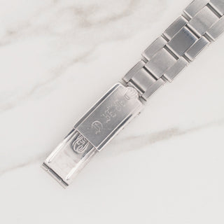 Full view of the folded stainless steel rivet bracelet and closed clasp face on a vintage Rolex