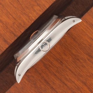 Angled top perspective showcasing the acrylic crystal, winding crown, and lug lines on a Rolex 6494