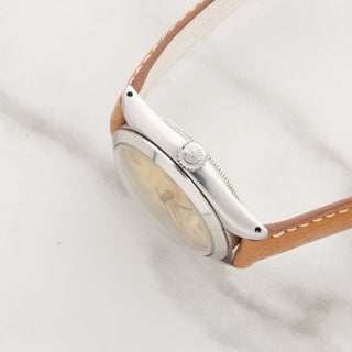 Side profile view showcasing the thickness, lugs, and winding crown of a vintage Rolex Oysterdate 6466
