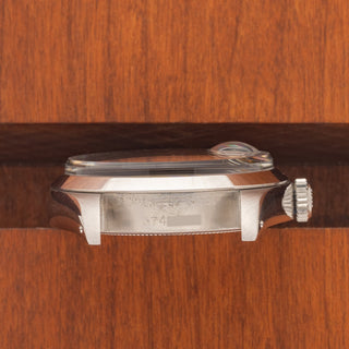 Horizontal case profile showing the sharp smooth bezel and clear 6694 reference engraving between the lugs