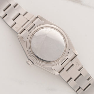 The clean stainless steel Oyster caseback and brushed lug undersides of a vintage Rolex Oysterdate 6694