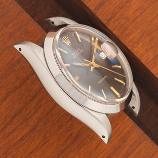 Angled top view highlighting the thick case proportions and deep black glossy dial of a 1980 Rolex Oysterdate