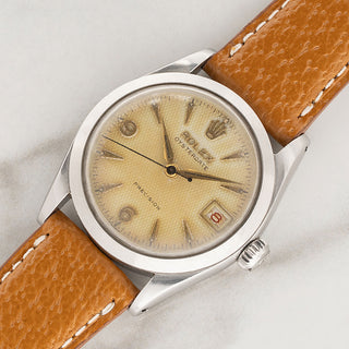 Angled view of the 30mm stainless steel case and aged waffle dial of a 1957 Rolex Oysterdate Honeybee