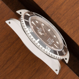 Close-up view highlighting the pristine factory chamfers and satin finish on a Rolex Submariner 14060M