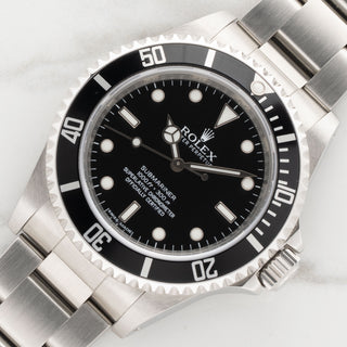 Angled view showcasing the unpolished case lines and black aluminum bezel insert of a Rolex Submariner 14060M