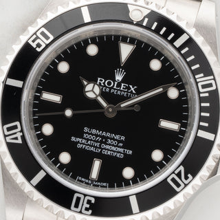 Macro close-up of the pristine four-line COSC dial and Luminova markers on a 2010 Rolex Submariner 14060M