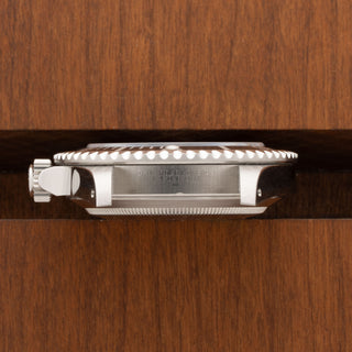 Horizontal profile view displaying the unpolished case side and sharp lug contours of a Submariner 14060M