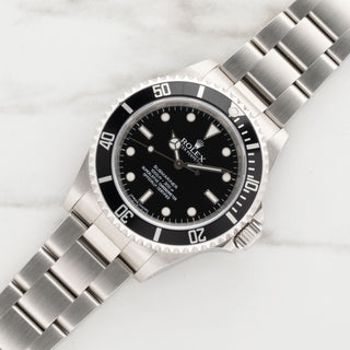 Near mint Rolex Submariner 14060M Four Line COSC watch on stainless steel Oyster bracelet at Collectors Corner New York