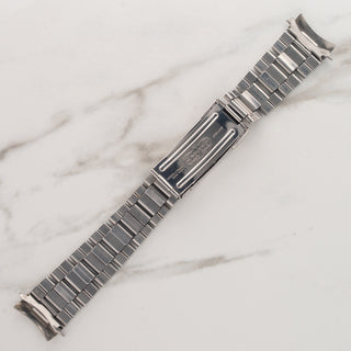 Underside view showing the folded stainless steel links and clasp mechanism of a Rolex Oyster bracelet