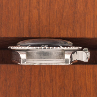 Horizontal case profile showing the crown guards, signed crown, and clear 3.6M serial number engraving between the lugs