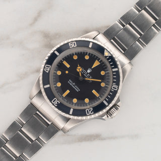 1975 Rolex Submariner reference 5513 with vibrant pumpkin patina and faded navy bezel on a stainless steel folded-link Oyster bracelet at Collectors Corner NY