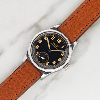 1940s Tissot Antimagnetique in stainless steel with black glossy gilt dial and radium Arabic numerals on a cognac leather strap at Collectors Corner NY