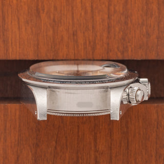 Horizontal case profile showing the screw-down pushers, crown guards, signed crown, and clear serial engraving