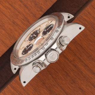 Angled top perspective showcasing the unpolished case chamfers, Rolex-signed crown, and screw-down pushers on a Tudor 79180