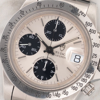 Macro close-up shot of the silver dial, black chronograph registers, date cyclops, and intact lume plots on a Tudor Big Block