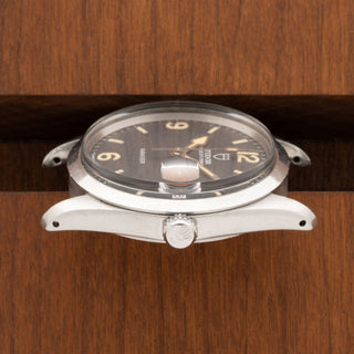 Horizontal profile detail showcasing the unpolished case edges and signed winding crown of a Tudor Ranger Date