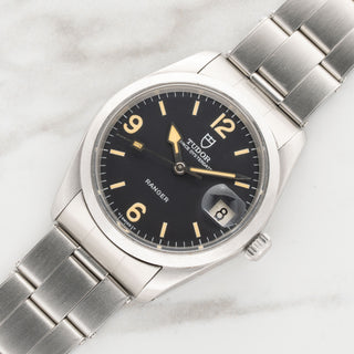 Angled view highlighting the sharp, unpolished stainless steel case and smooth bezel of a vintage Tudor Ranger Date