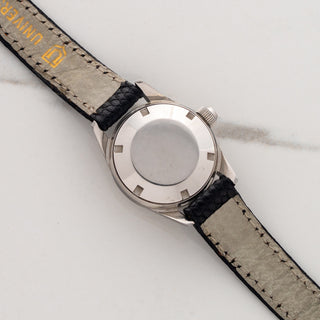 The clean stainless steel screw-down caseback and signed leather strap underside on a ladies Universal Genève Polerouter