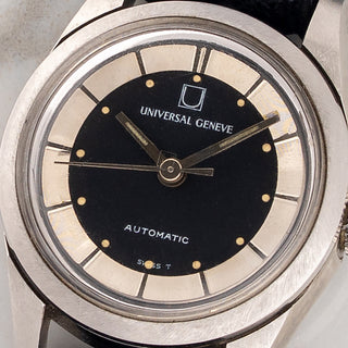 Macro close-up shot of the two-tone black and silver crosshair dial and tritium plots on a ladies Universal Genève Polerouter