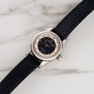 Unpolished ladies Universal Genève Polerouter automatic watch with two-tone black and silver dial on a black leather strap at Collectors Corner NY
