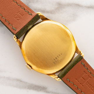 Solid 18k yellow gold caseback displaying crisp reference and serial number engravings on a vintage Universal Genève 10750
