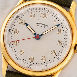 Macro close-up shot of the silvered dial, radium Arabic numerals, thermally blued hands, and red sweep seconds hand on a Universal Genève 10750