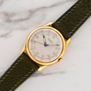 1940s Universal Genève reference 10750 in 18k yellow gold with radium Arabic dial and blued hands on an olive green leather strap at Collectors Corner NY