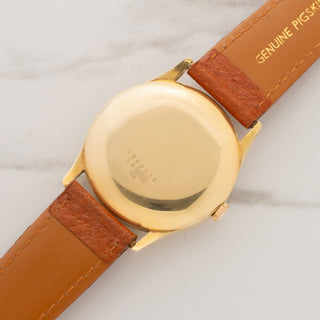 18k yellow gold caseback view showing visible reference 1509623 and serial number markings on a Universal Genève.