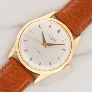 Angled shot highlighting the 34mm 18k yellow gold case and silver dial of a vintage Universal Genève Calatrava