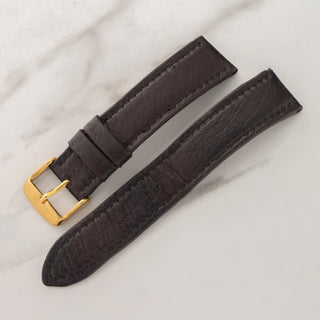 Included additional black leather watch strap with gold-toned pin buckle