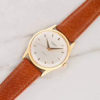 18k yellow gold Universal Genève Calatrava reference 1509623 automatic dress watch on a tan leather strap at Collectors Corner NY