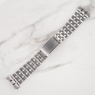 Detail view of the iconic Gay Frères stainless steel bracelet links signed by Universal Genève