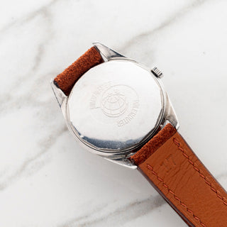 Angled view of the stainless steel caseback showing the crisp Universal Genève logo and reference 204610-2 stamp
