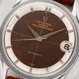 Macro close-up shot of the tropical milk chocolate gilt dial, date window, silver chapter ring, and crosshair detail on a Universal Genève Polerouter Date